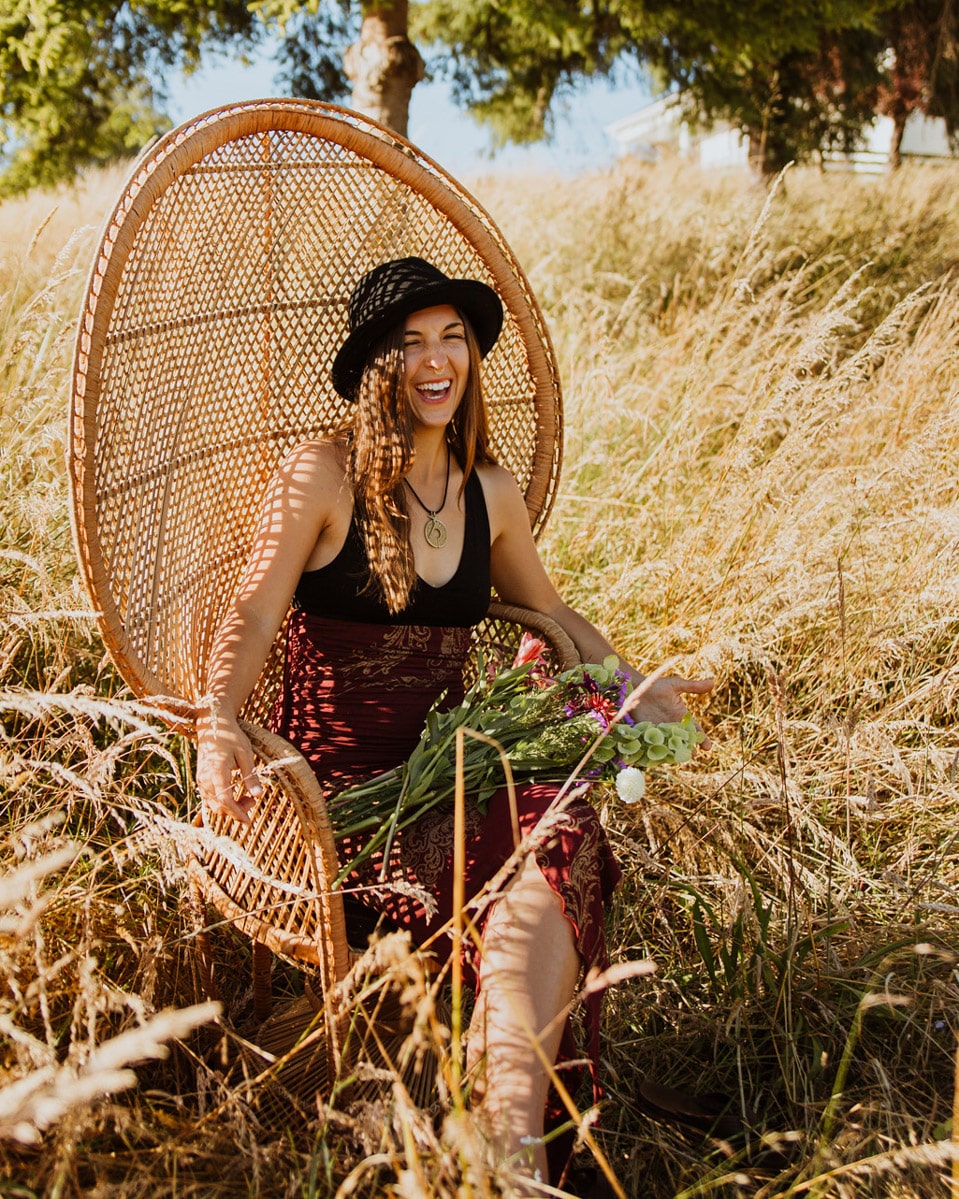 lauryn lavandula somatic embodiment coach laughing in a chair